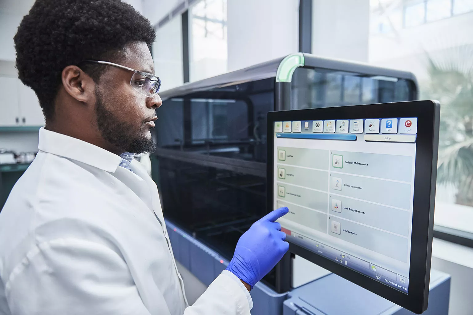 Técnico de laboratório a tocar no monitor do sistema Panther®.