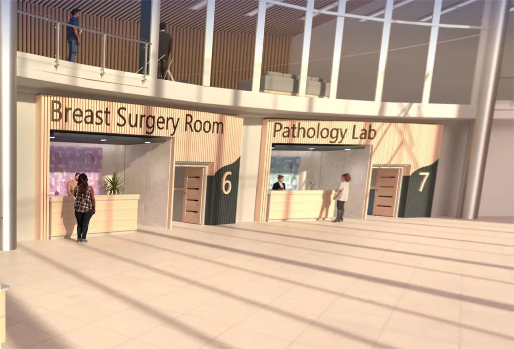 Mulheres no Hospital Virtual, uma a dirigir-se à Sala de Cirurgia da Mama e a outra ao Laboratório de Patologia